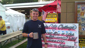 A man savouring a hot beverage in a mug.