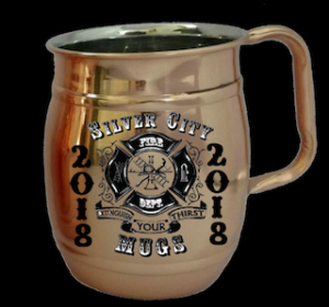 A copper mug with an image of a firefighter on it.
